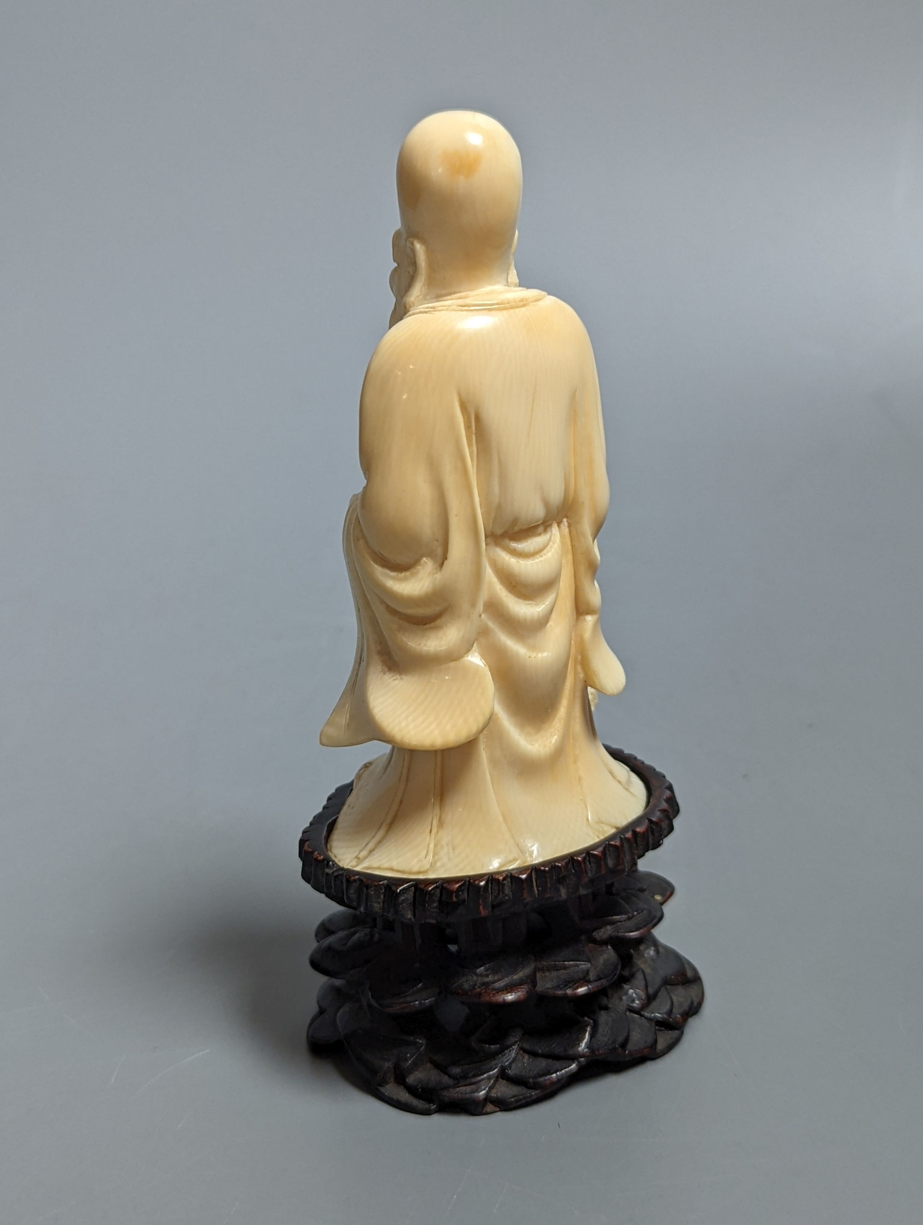 An early 20th century Chinese carved ivory figure of Shao Lao on stand and a jade figural carving 13cm